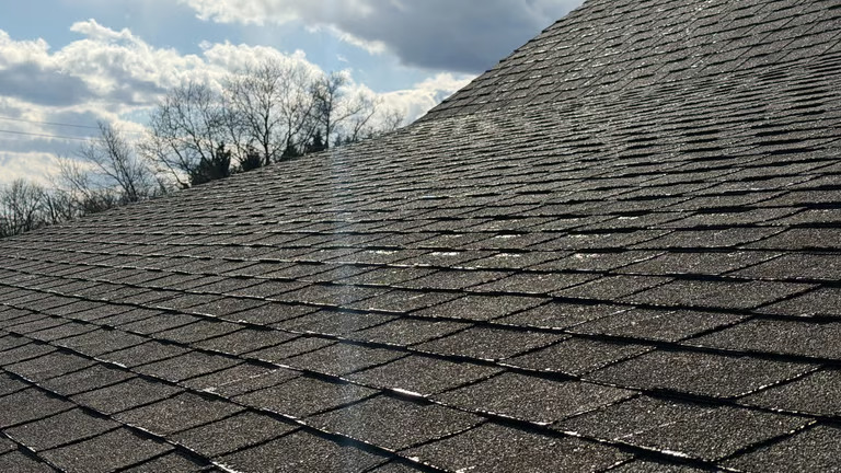 View along a roof ridge under a partly cloudy sky